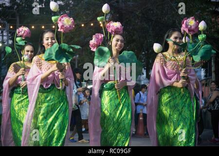 The parade of Thai pretty woman holding lotus flower show on street of Loykratong festival Stock Photo