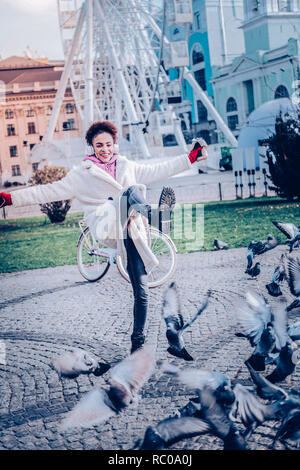 Amazing brunette girl having fun with pigeons Stock Photo