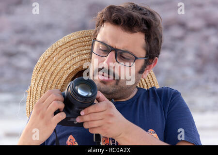 Photographer taking pictures in the beach of Urmia Lake, West Azerbaijan province, Iran Stock Photo
