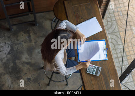 Young female working with many reports and documents Stock Photo