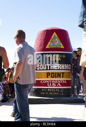 24 December 2018 - Key West, Florida, USA. Tourists photographing at the southernmost point in the continental USA, indicating 90 miles to Cuba.
