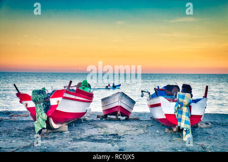 Nice sunset with fishing boats on the beach of Oued Laou, in the province of Chaouen, a traditional fishing village on the Mediterranean coast of Moro Stock Photo