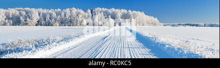 beautiful winter landscape panorama with road and forest. panoramic view of snow covered forest and field