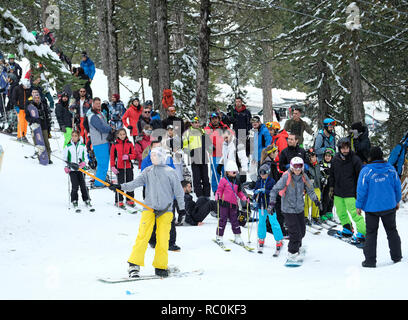 Skiers and snow boarders enjoy fine conditions at the Sun Valley ski resort on the slopes of Mount Olympus in the Troodos Mountains, Cyprus. Stock Photo