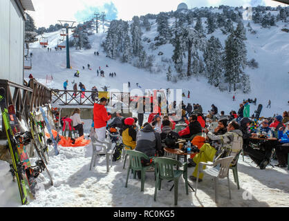 Skiers and snow boarders enjoy fine conditions at the Sun Valley ski resort on the slopes of Mount Olympus in the Troodos Mountains, Cyprus. Stock Photo