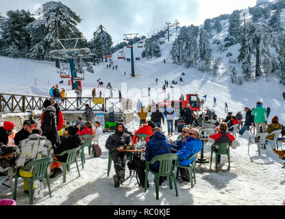 Skiers and snow boarders enjoy fine conditions at the Sun Valley ski resort on the slopes of Mount Olympus in the Troodos Mountains, Cyprus. Stock Photo