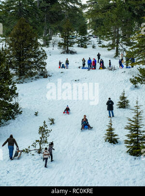 Skiers and snow boarders enjoy fine conditions on the slopes of Mount Olympus in the Troodos Mountains, Cyprus. Stock Photo