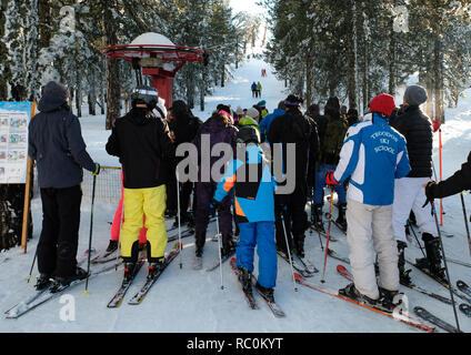 Skiers and snow boarders enjoy fine conditions at the Sun Valley ski resort on the slopes of Mount Olympus in the Troodos Mountains, Cyprus. Stock Photo