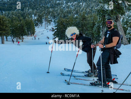 Skiers and snow boarders enjoy fine conditions at the Sun Valley ski resort on the slopes of Mount Olympus in the Troodos Mountains, Cyprus. Stock Photo