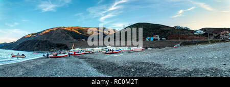 Oued Laou, Chefchaouen, Morocco - November 3, 2018:Fishermen preparing their small boats to go fishing. Oued Laou beach, in the  Chefchaouen province. Stock Photo