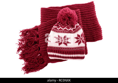 Red knitted wool winter bobble hat scarf isolated white background. Stock Photo