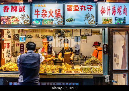 CHENGDU, CHINA - SEPTEMBER 25: This is a street food vendor selling local Sichuan food at Jinli Ancient Steet at night on September 25, 2018 in Chengd Stock Photo