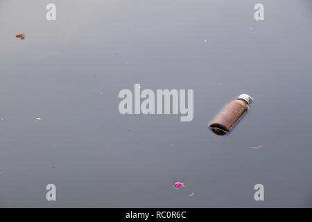 Rusty bottles floating in the waste water background. Stock Photo