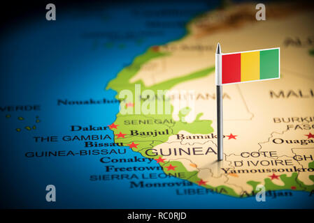 guinea Belgium marked with a flag on the map Stock Photo