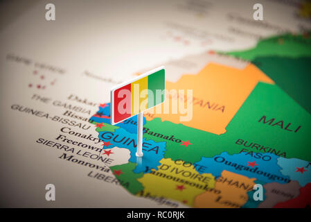 guinea Belgium marked with a flag on the map Stock Photo