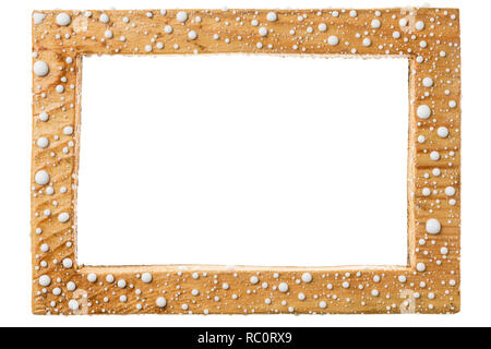 Beautiful wooden frame in drops of white paint. Isolated on white background. Stock Photo