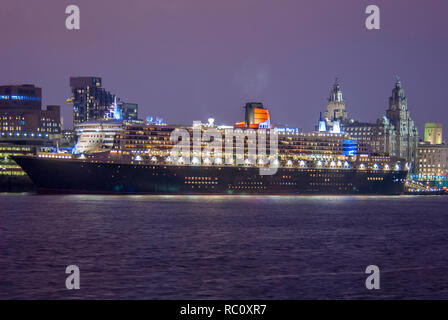 Cunard cruise liner the Queen Mary 2 at night berthed at Liverpool pier head landing stage. 2009 Stock Photo