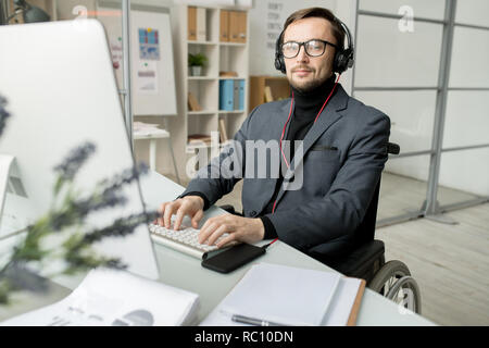 Disabled businessman working on computer Stock Photo