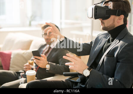 Using virtual reality device during business break Stock Photo