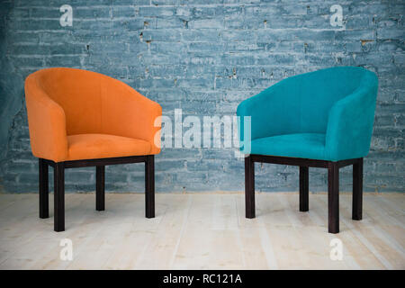 Two chairs against a gray brick wall. Interior. Stock Photo