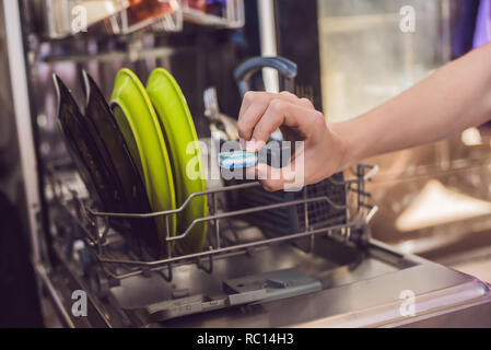 Dishwasher with dirty dishes. Powder, dishwashing tablet and rinse aid. Washing dishes in the kitchen Stock Photo