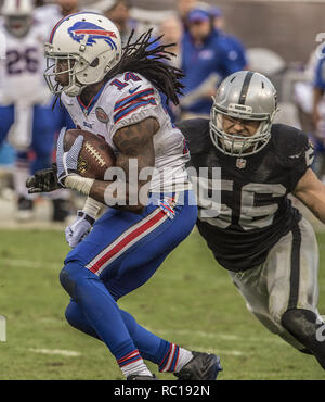 Oakland Raiders defensive end Justin Tuck (91), middle linebacker Miles  Burris (56) and safety Charles Woodson (24) surround Kansas City Chiefs  tight end Travis Kelce (87) as he picks up a first