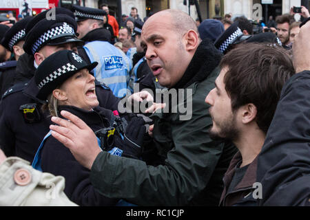 London, UK. 12th January, 2019. Police officers keep order between around fifty supporters of far-right group Liberty Defenders and hundreds of protesters taking part in a 'Britain is Broken: General Election Now' demonstration organised by the People's Assembly Against Austerity. Some members of both groups were wearing yellow vests in solidarity with the 'gilets jaunes' in France. Credit: Mark Kerrison/Alamy Live News Stock Photo