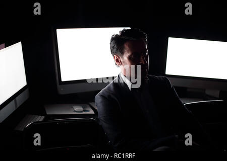 tired businessman working in the computer room late. Stock Photo