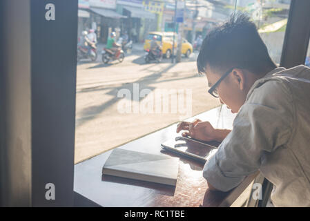 Asian young student using tablet Stock Photo
