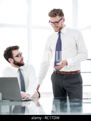 two employees discuss business issues near the office Desk Stock Photo