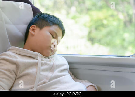 Fat boy is sleeping on train, relax and travel concept Stock Photo