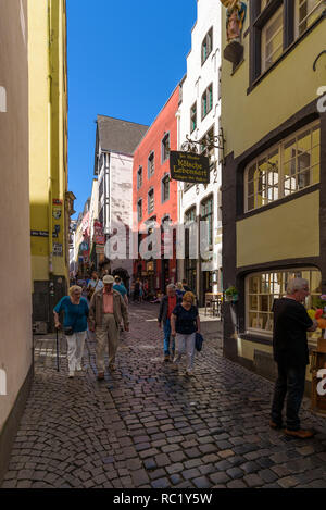 Salzgasse, popular touristic spot with traditional colourful buildings connecting Heumarkt square with Rhine River waterfront Frankenwerft. Cologne. Stock Photo