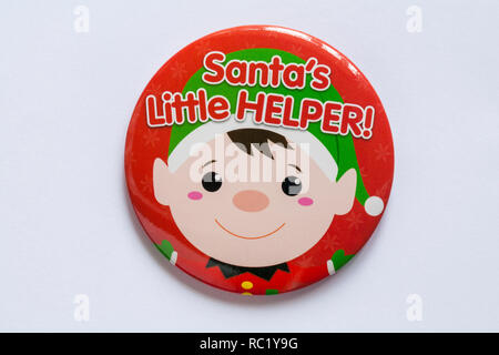 Santa's Little Helper red round badge, pin badge, isolated on white background - for wearing at Christmas Stock Photo