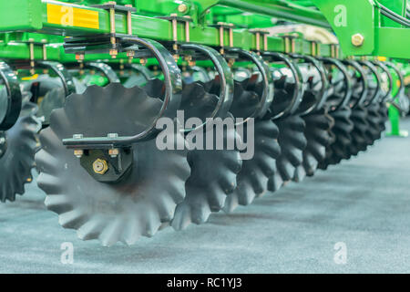 Corn harvester head with several silver blades. Agricultural machinery for soil cultivation Stock Photo