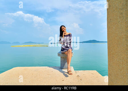 Beautiful woman posing - sitting, cross legged and enjoying Stock Photo