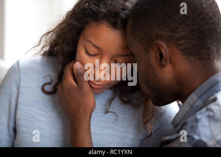 Loving african american husband apologizing comforting sad upset Stock Photo