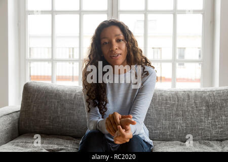 Serious friendly african woman internet tutor looking at camera  Stock Photo