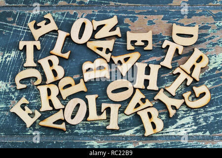 Wooden letters scattered on rustic wooden surface Stock Photo