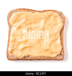 Bread slice with mustard sauce isolated on white, clipping path. Slice of multigrain bread square form plaster mustard sauce for toast. Image of one slice wholegrain bread, top view or flat lay. Stock Photo