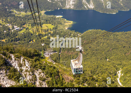 Gondola ski lift in summer taking hikers into the mountains overlooking lake Bohinj near Bled, Slovenia Stock Photo