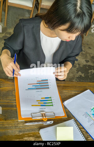 Businesswoman doing cross-check of data Stock Photo