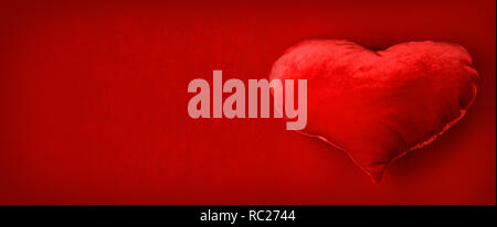 Red pillow heart on red fabric background, Valentines day Stock Photo