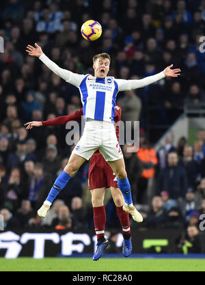 Solly March of Brighton gets a shove in the back during the Premier League match between  Brighton & Hove Albion and Liverpool at the American Express Community Stadium . 12 January 2019 Editorial use only. No merchandising. For Football images FA and Premier League restrictions apply inc. no internet/mobile usage without FAPL license - for details contact Football Dataco