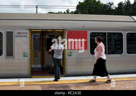 Passengers boarding a train at Roma Street station, Brisbane, Queensland, Australia Stock Photo