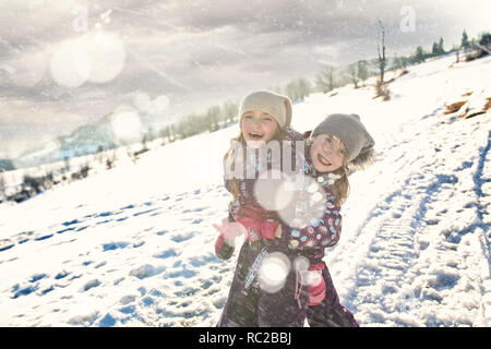 Young friends in the snow are fooling around Stock Photo