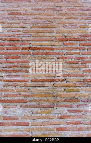 Red Brick wall. Mediterranean style. Aged wall. Concrete and  yellowish bricks. Stock Photo