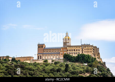 Facade and dome of the Tindari Sanctuary, built on a cliff with sheer drop on the sea and panoramic views of the Aeolian Islands and the gulf of Patti Stock Photo