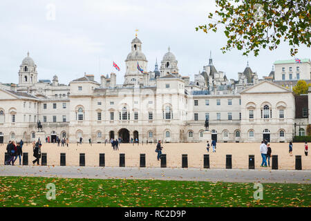 London, United Kingdom - October 29, 2017: Tourists walk on the square of Horse Guards, historic building in the City of Westminster, London Stock Photo