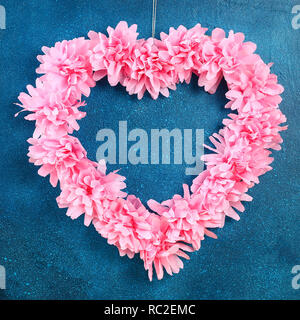 Heart shaped wreath decorated artificial flower made pink tissue paper napkins. Gift ideas for Valentines Day, decor for day love, concept February 14 Stock Photo