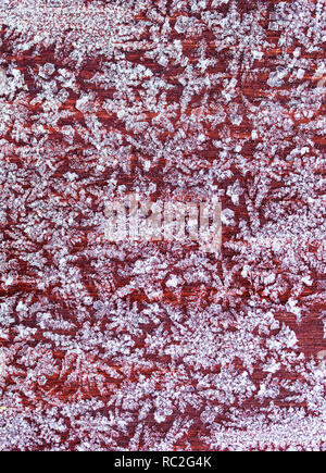 beautiful festive background from white ice crystals patterns texture on a wooden surface Stock Photo